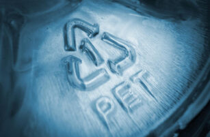Close-up of a plastic surface displaying the recycling symbol, the number 5, and the letters PP, indicating the material is polypropylene. The image has a cool blue tint and soft lighting.